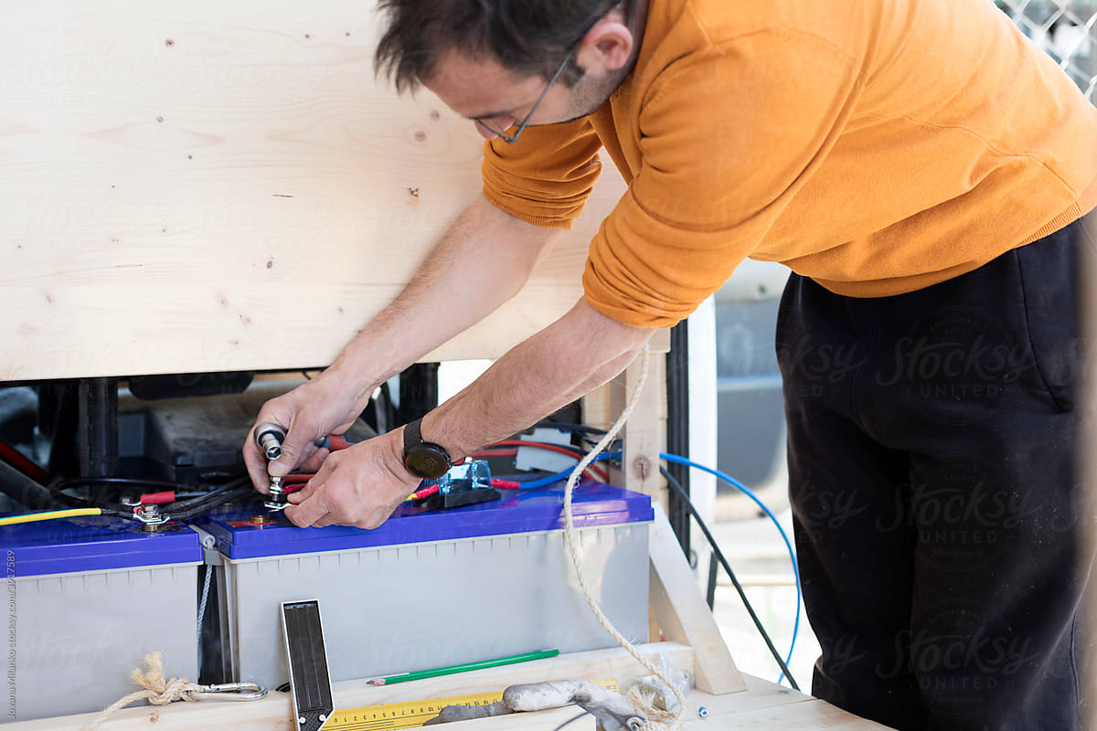 Man Installing Van Accumulator Battery for Solar Panel