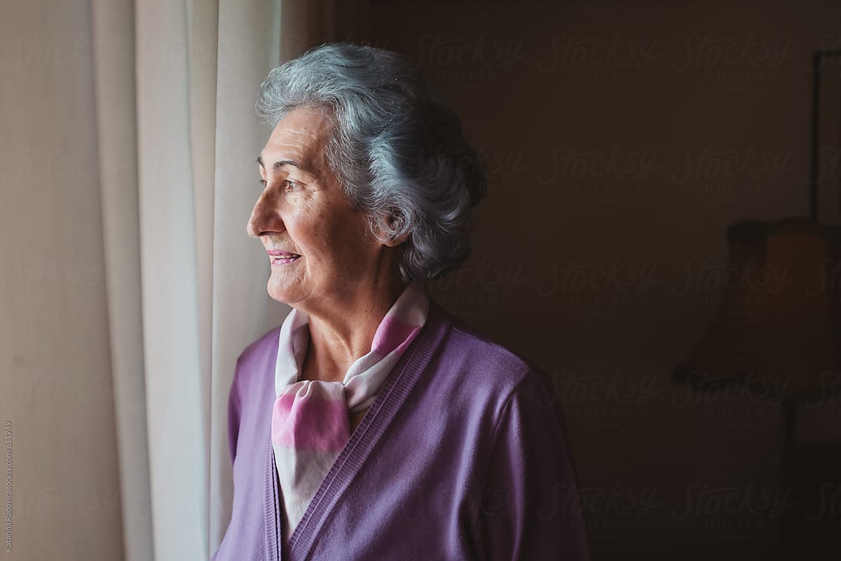Beautiful Senior Woman Looking Though the Window