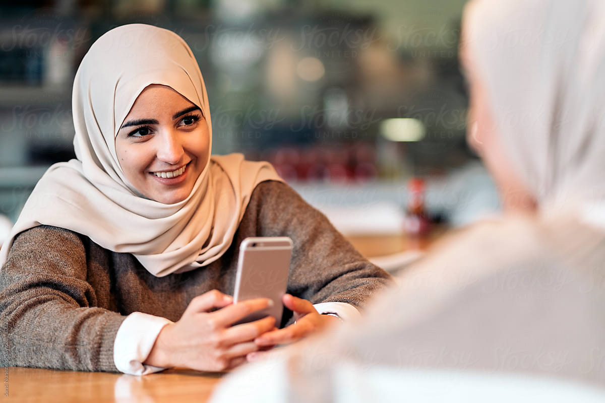 Muslim woman using her smartphone.