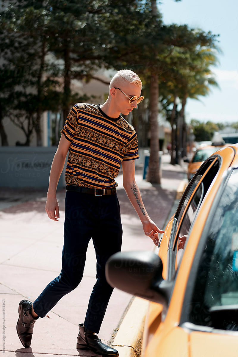 Stylish blond man taking a Taxi in Miami