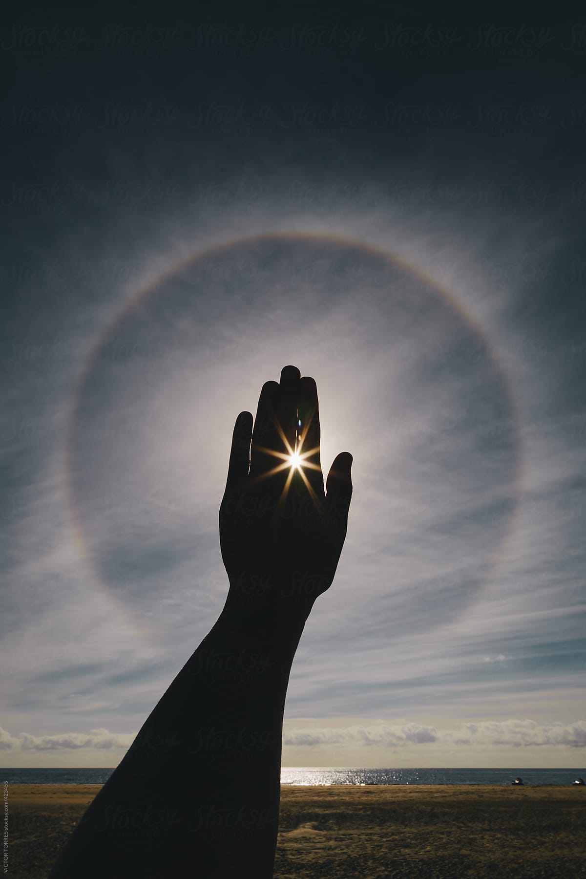 Man Hand Covering a Solar Halo
