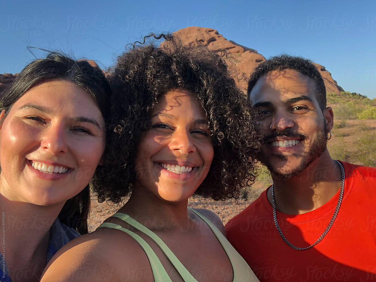 Three  Friends Hiking together in Arizona taking mobile phone selfie
