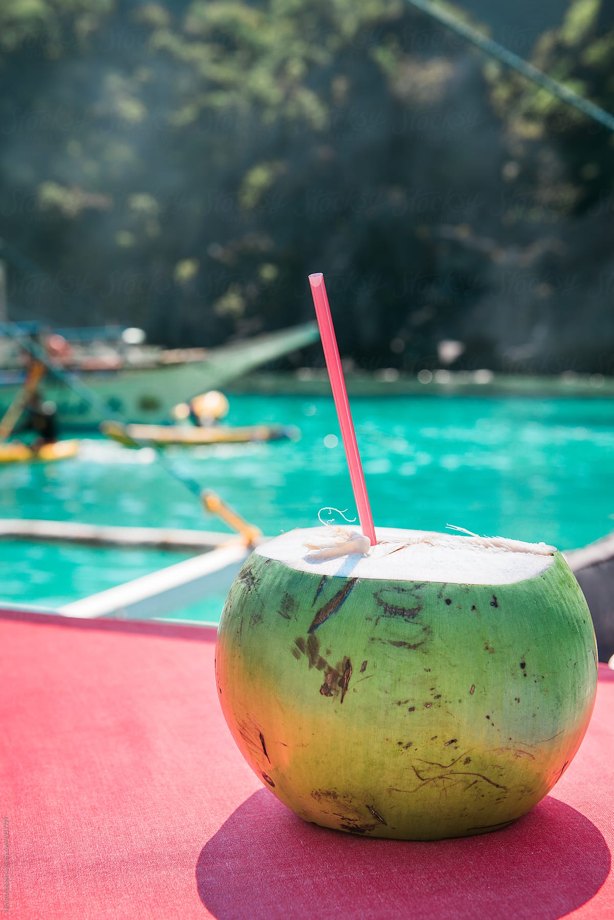 Fresh green coconut water drink aboard boat