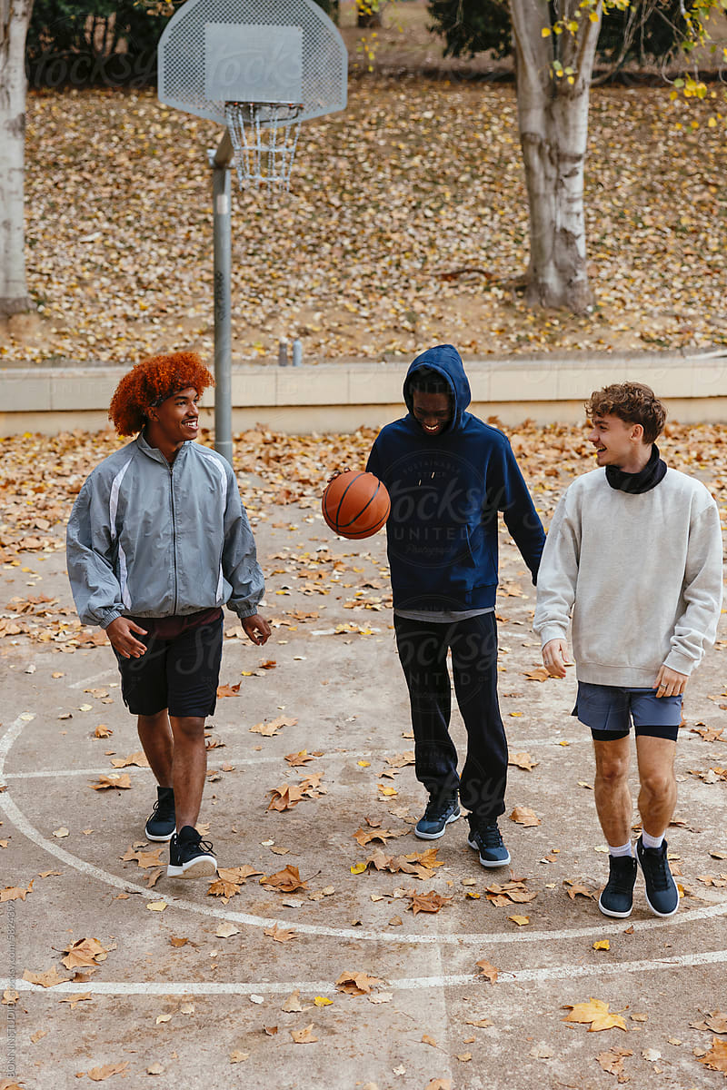 Group Of Friends Having Fun Together At An Outdoor Basketball Court