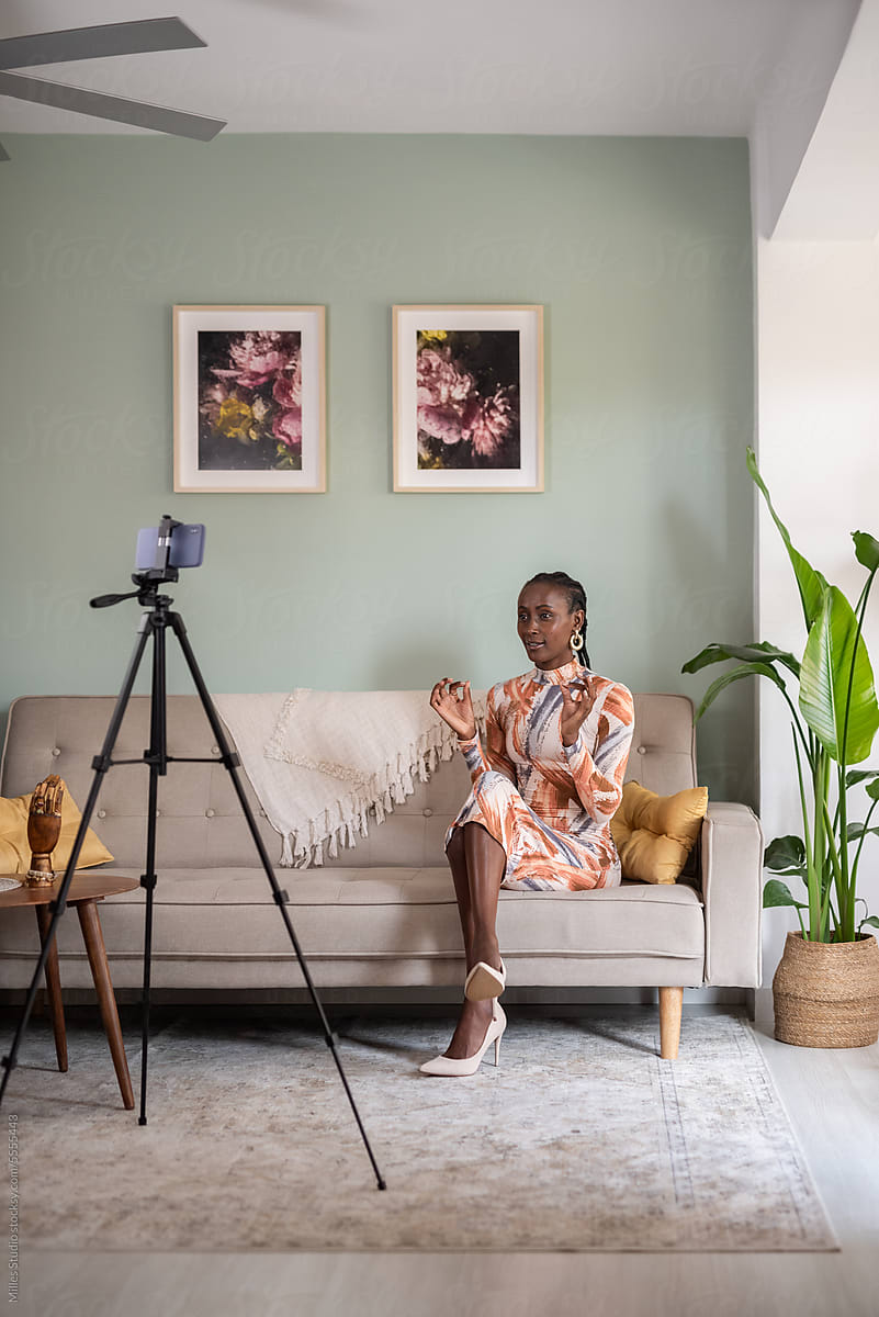Black female blogger recording video at home