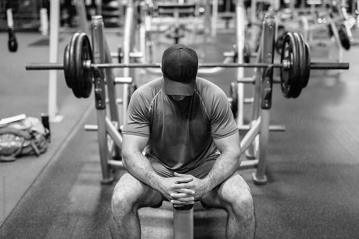 Man preparing to bench press weights at gym
