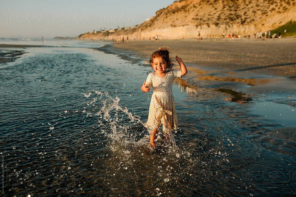 Laughing girl with symbrachydactyly at beach
