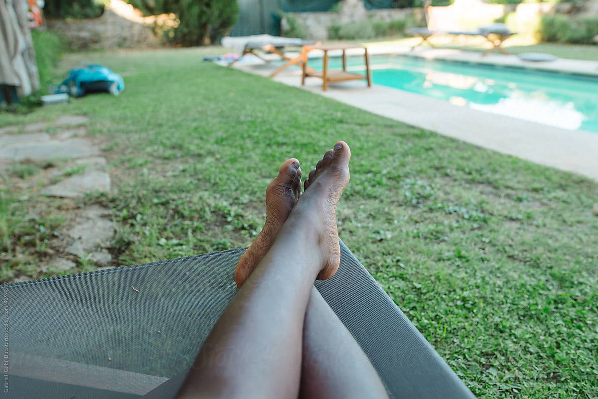 Black girl's legs by a pool