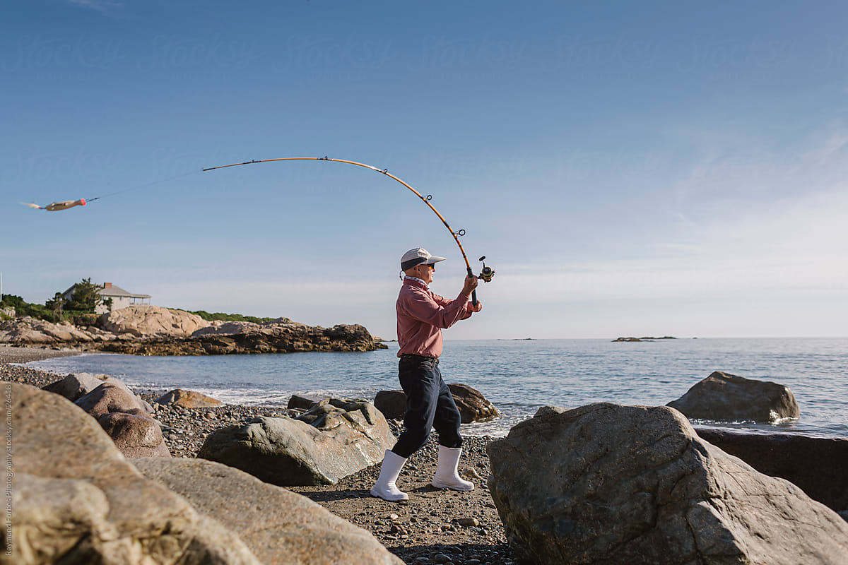 Active Senior Lifestyle of Man Fishing surf casting