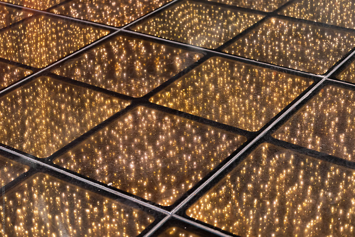 Party floor with tiles illuminated with golden lights