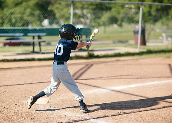 young baseball player sits on the bench by Stocksy Contributor Kelly  Knox