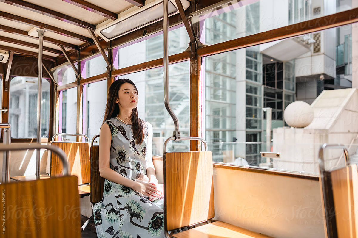 A woman sitting in a Ding Ding tram