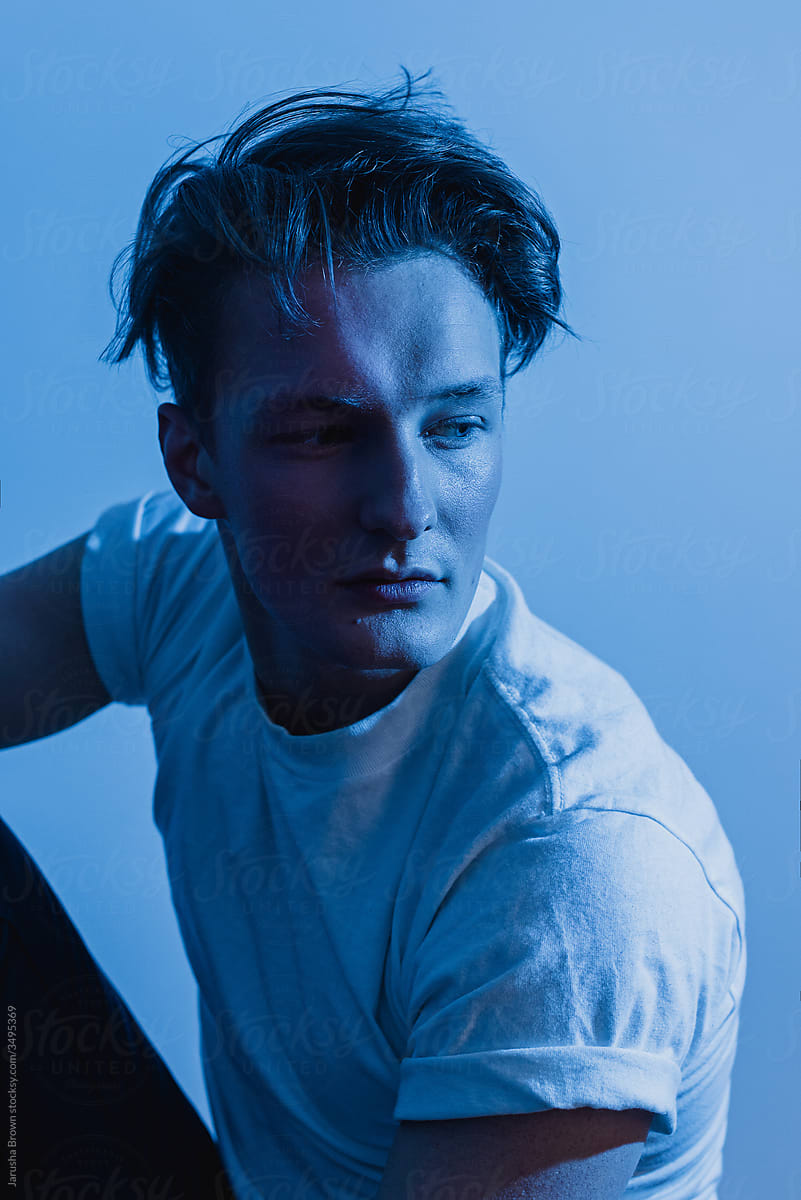 Portrait of a young man with blue light