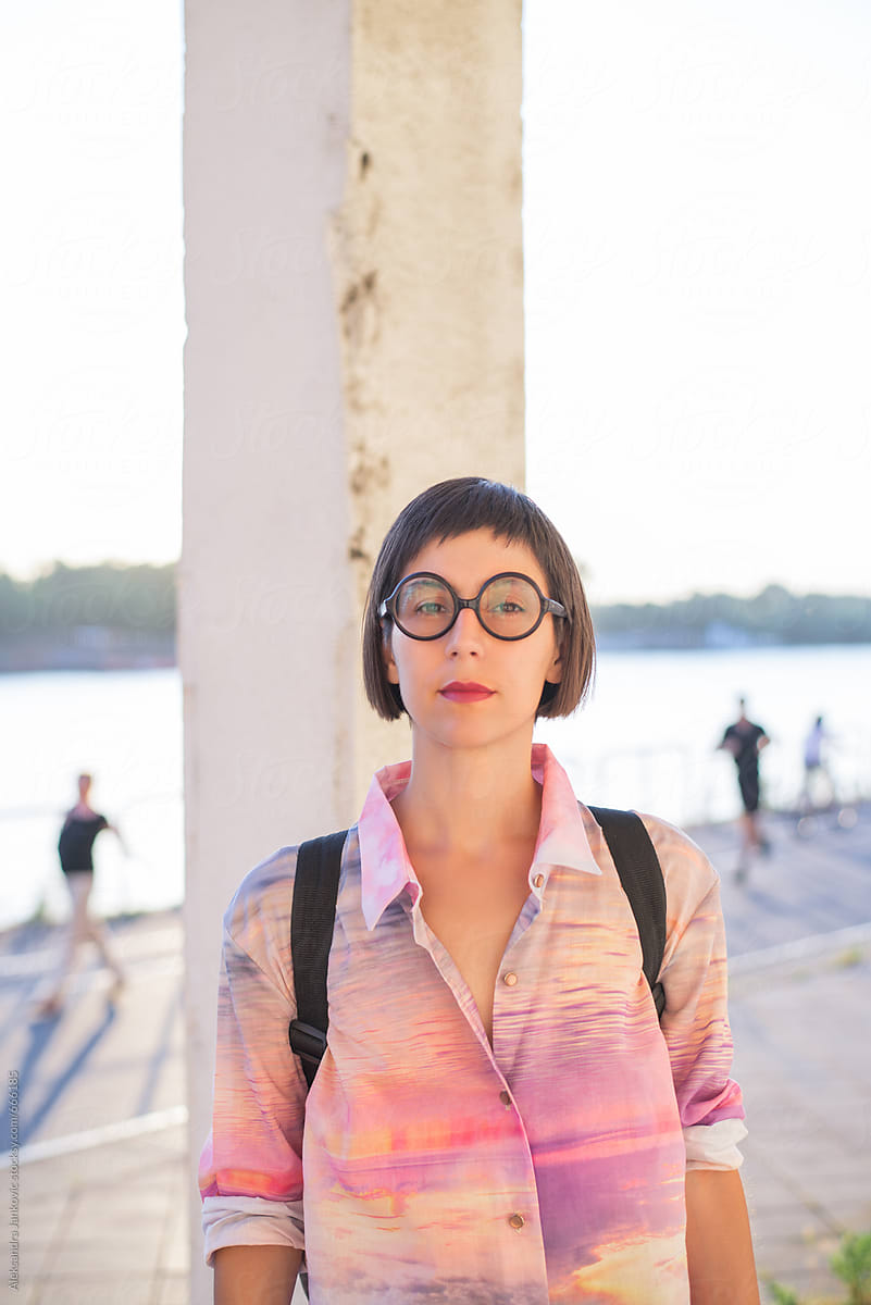 Portrait Of A Stylish Woman With Glasses Wearing A Pink Shirt