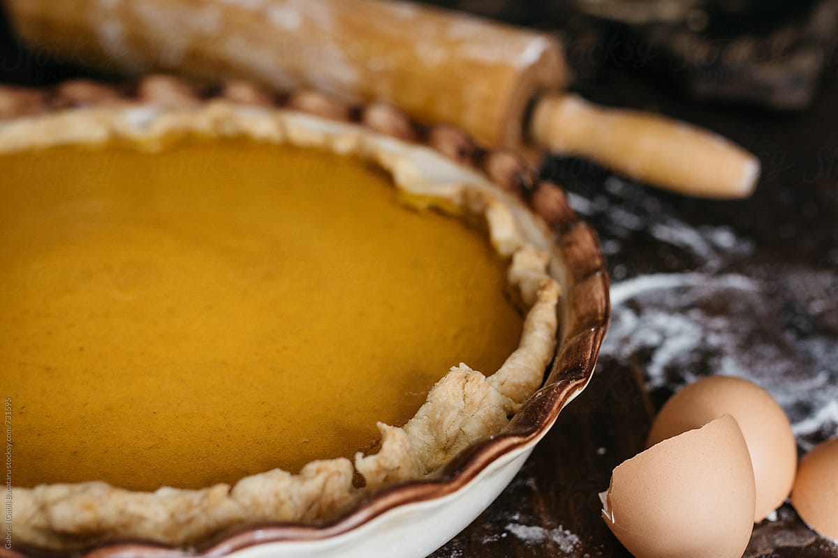 Pumpkin pie with rolling pin and egg shells