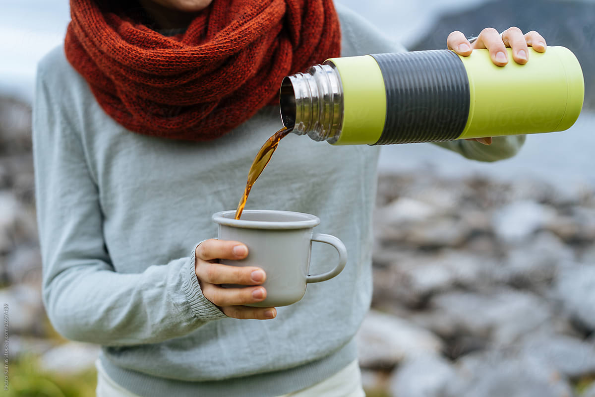 Crop Woman Pouring Hot Drink From Thermos by Stocksy Contributor