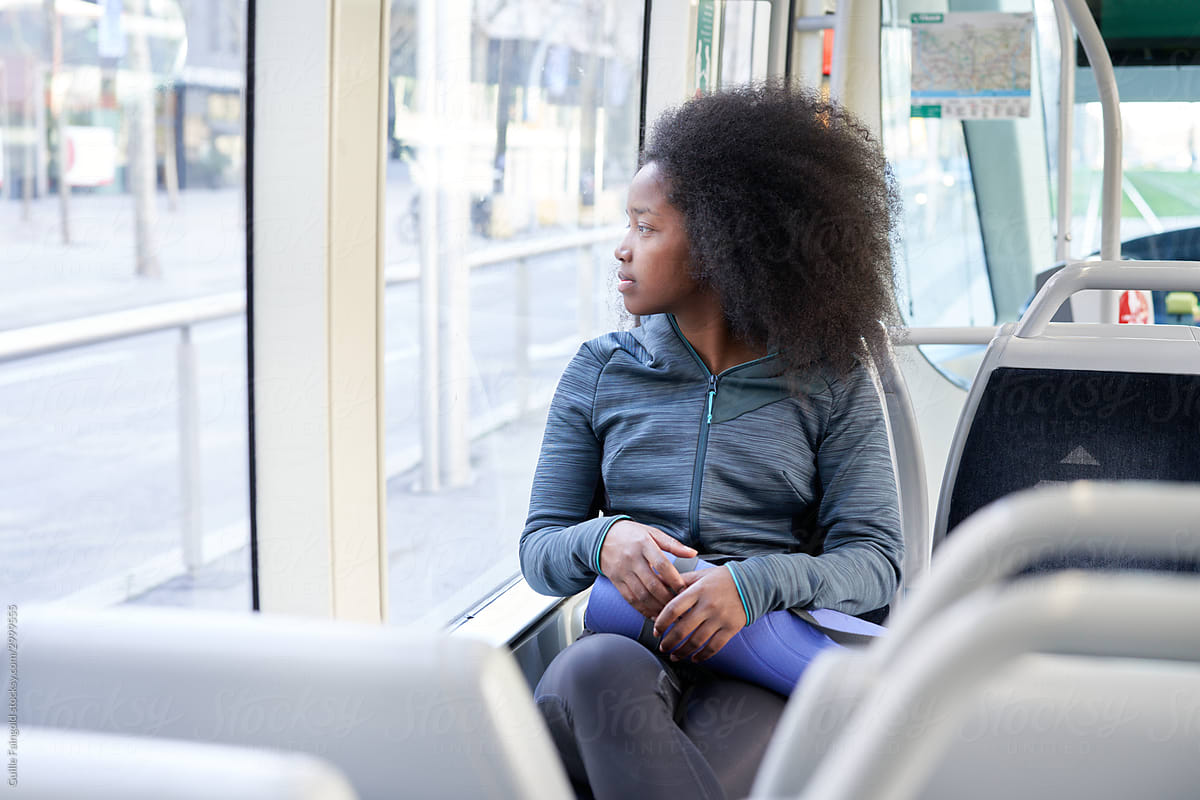 Pensive fit woman travelling by public bus
