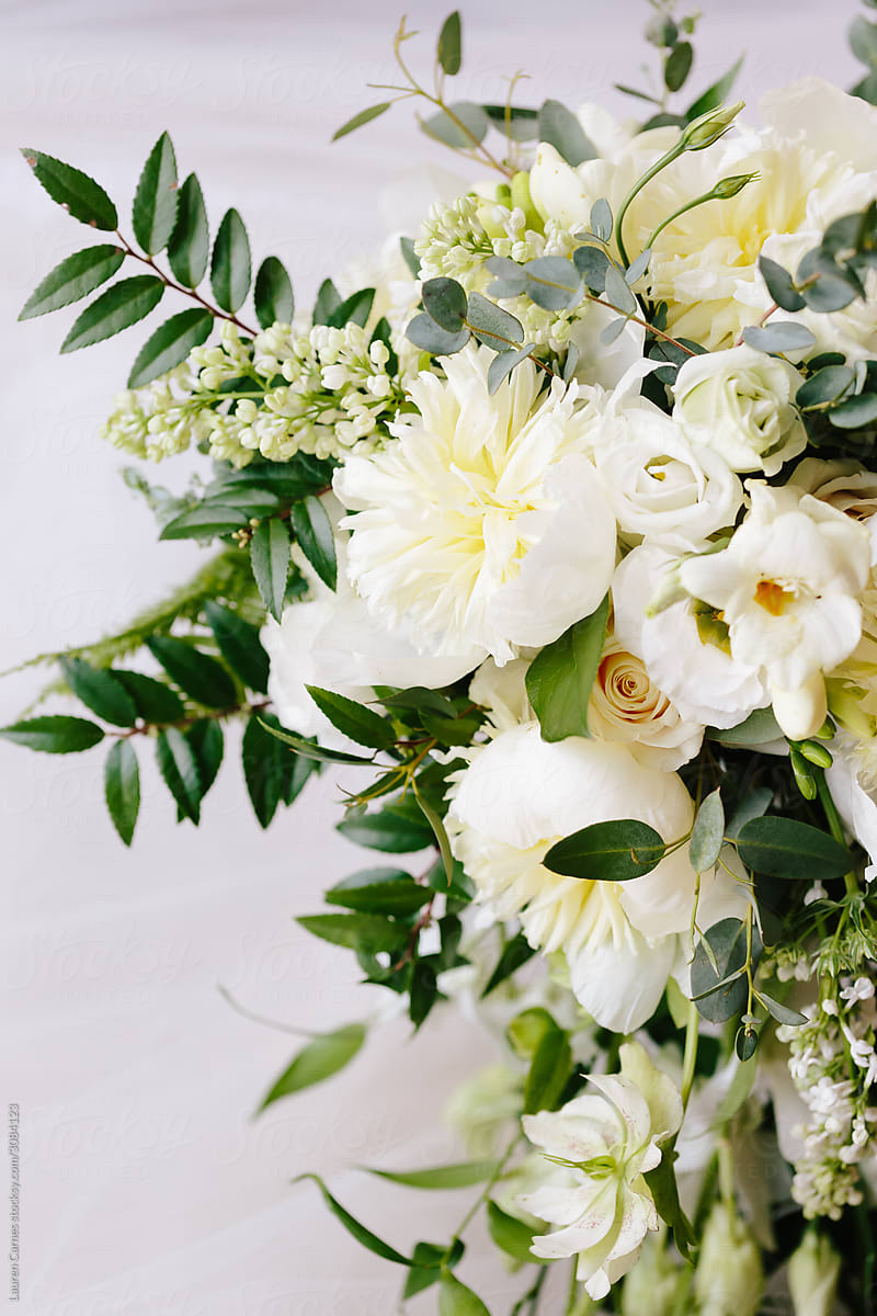 Bouquet of white flowers and greenery on white background