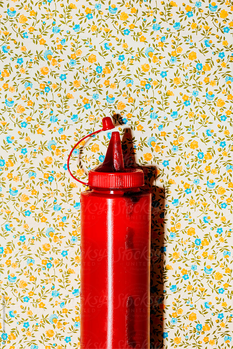 dirty ketchup dispenser on a floral background