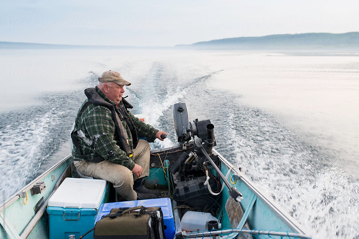 Large Middleage Man Fishing for Salmon In Boat With Downrigger