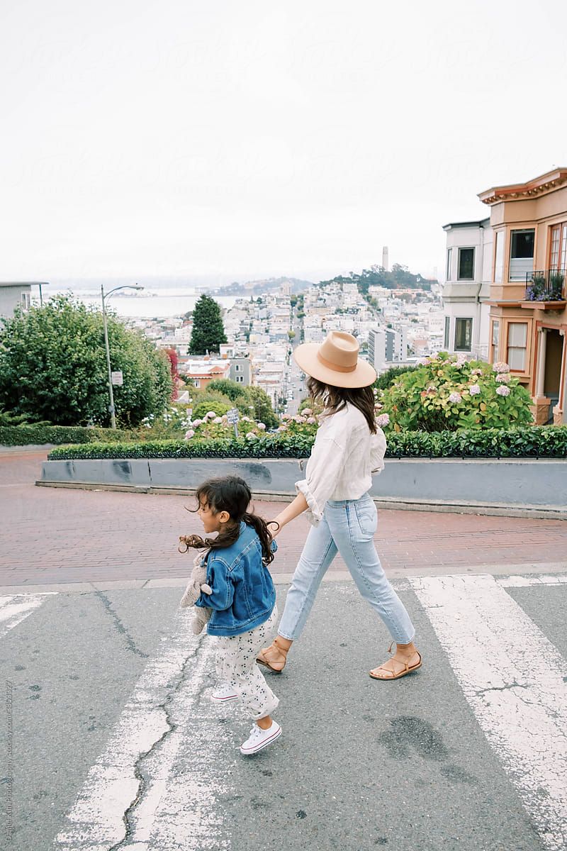Stylish Mom And Daughter Walk In The City by Stocksy Contributor