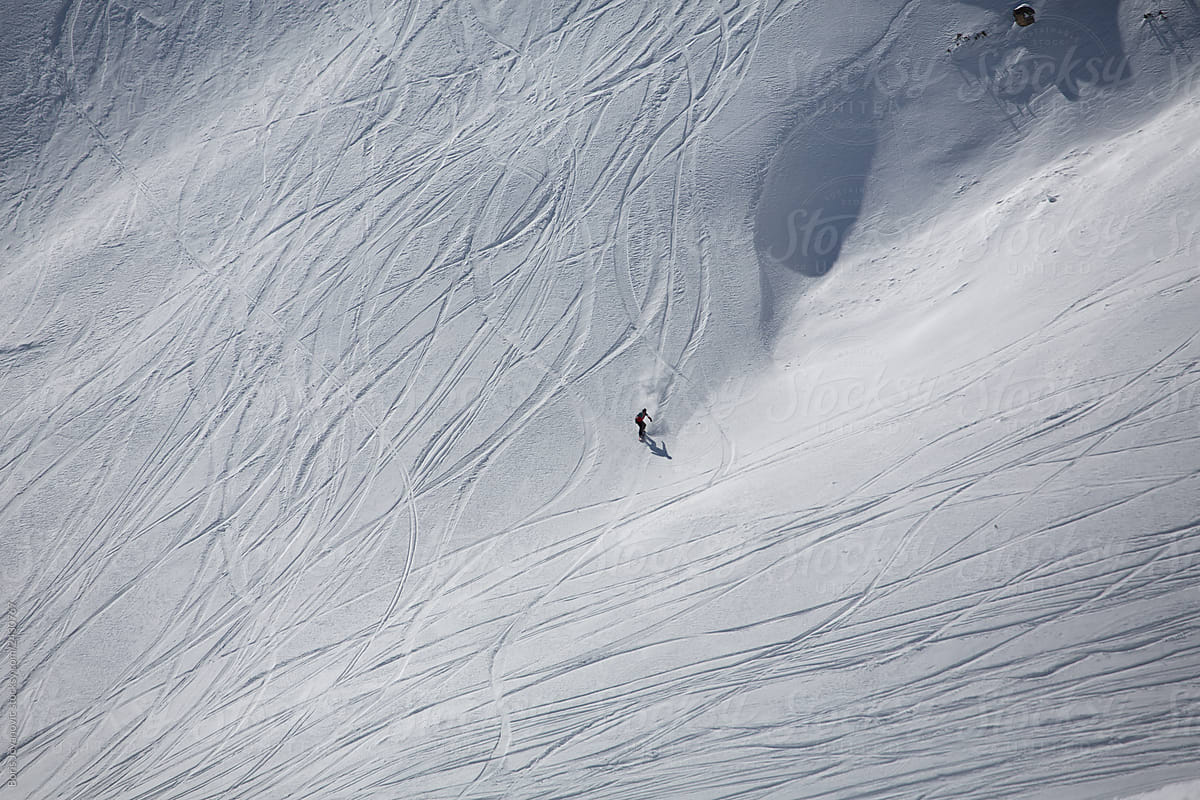 Snowboarder skiing outside the track
