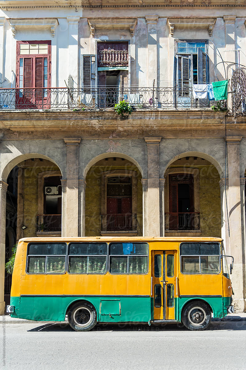 Old Yellow Bus Parked In Front Of Building