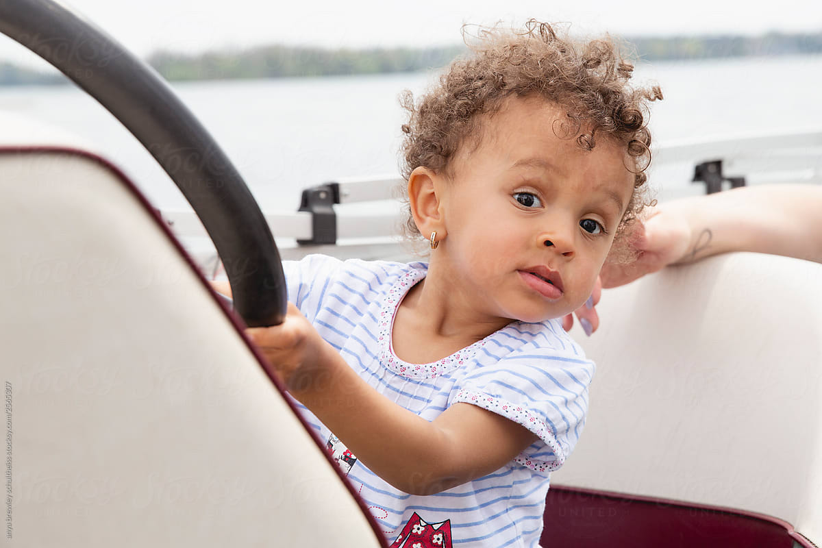 Toddler child pretending to sail a boat