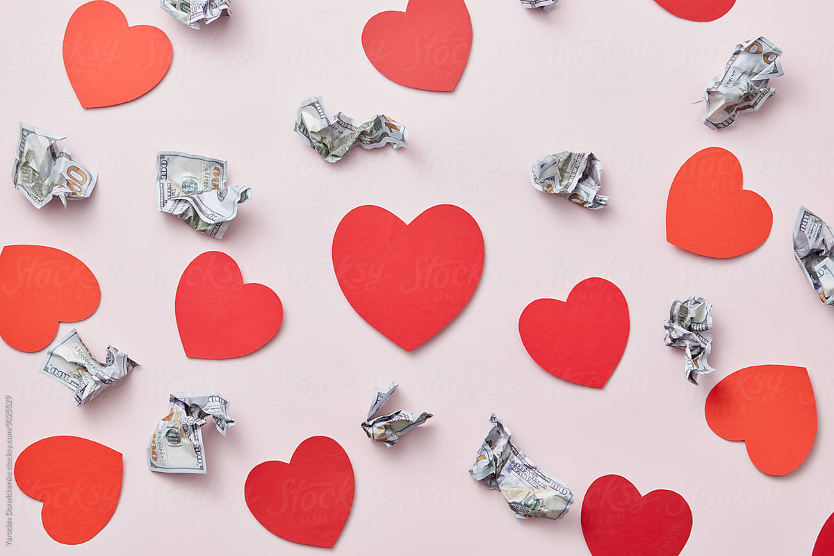 Valentine\'s pattern of dollars and paper hearts.