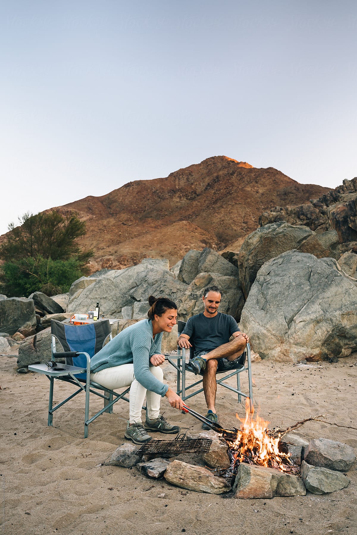 couple outdoors by a campfire