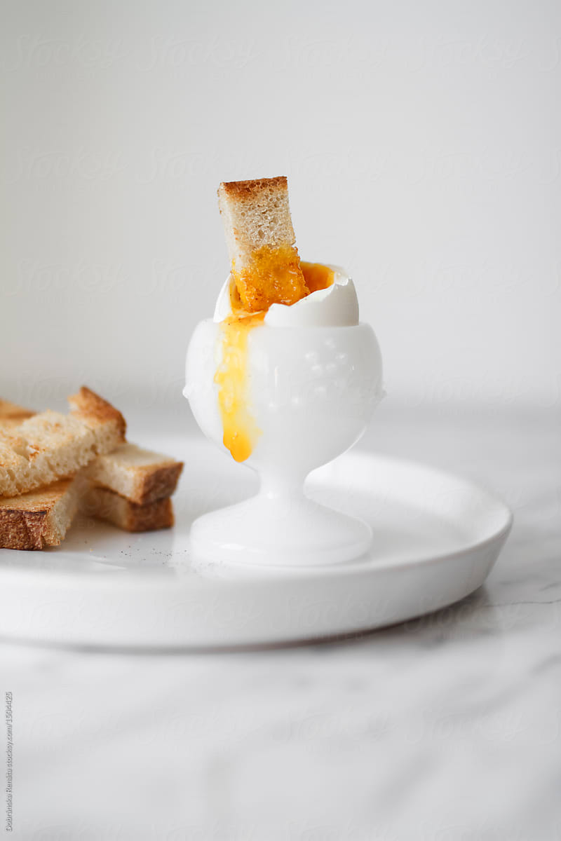 A soft-boiled egg with toast soldiers.
