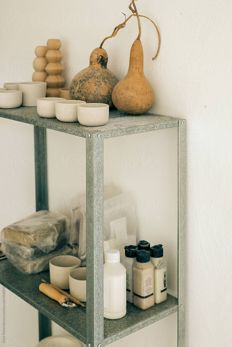 Unfired glasses and pottery tools on the shelf