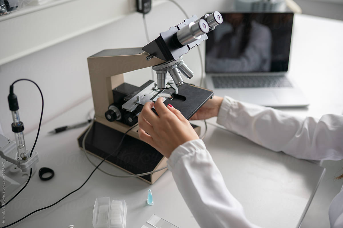 Anonymous Researcher Using Microscope In Lab