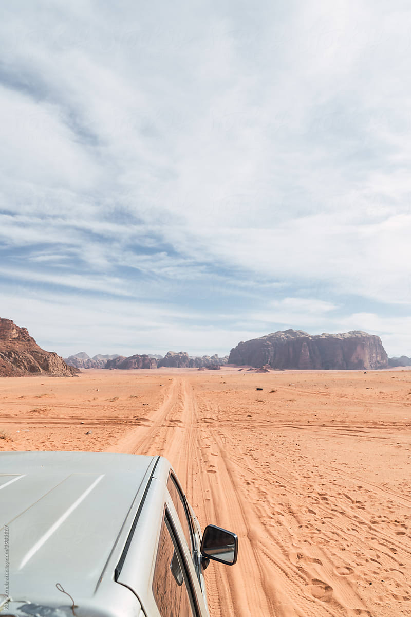 Car driving on sand road in desert