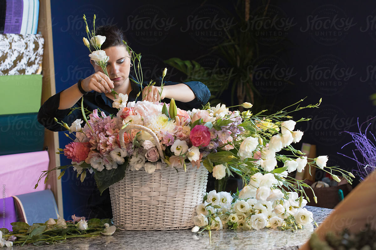 World of floristry, one day at the flower shop. Florist arranges flowers into a rich bouquet