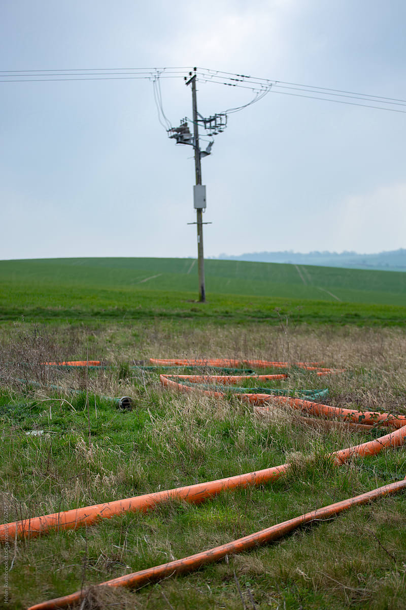 Orange irrigation pipes on rough farmland