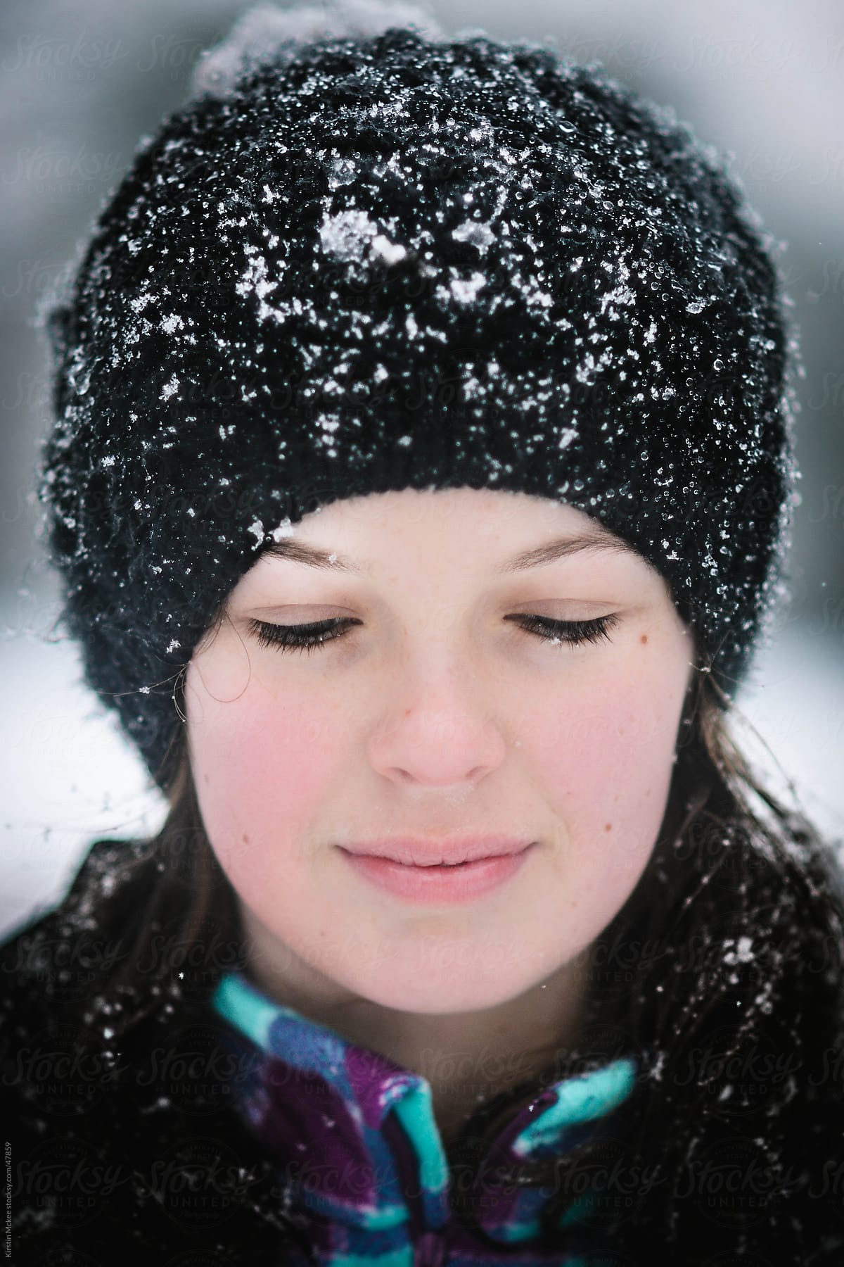 Caucasian girl with snow on her eyelashes.
