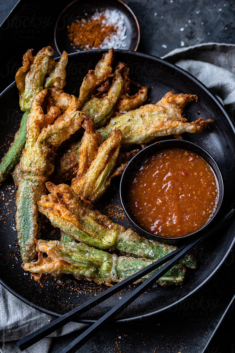 Zucchini flowers in tempura with spicy sauce and spices