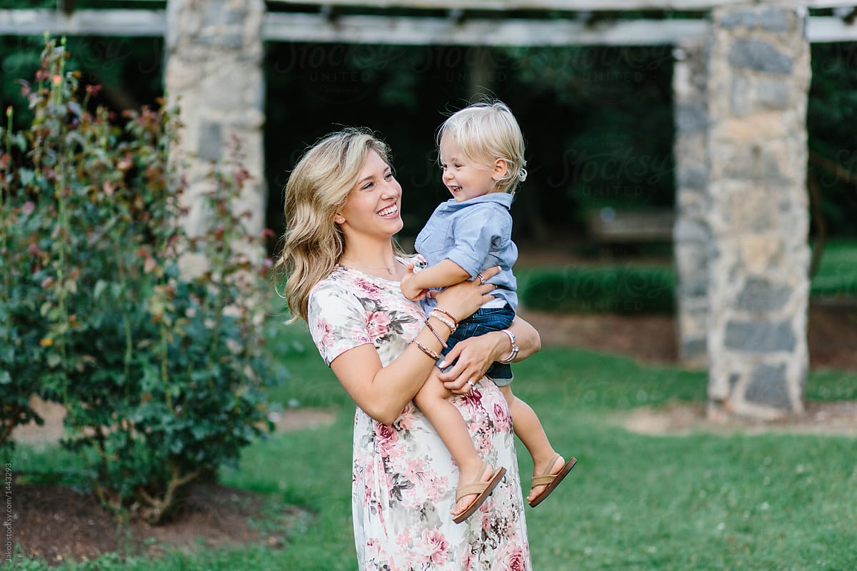 Pregnant Mother With Her Young Son Sitting On Er Belly Bump By Stocksy Contributor Jakob 