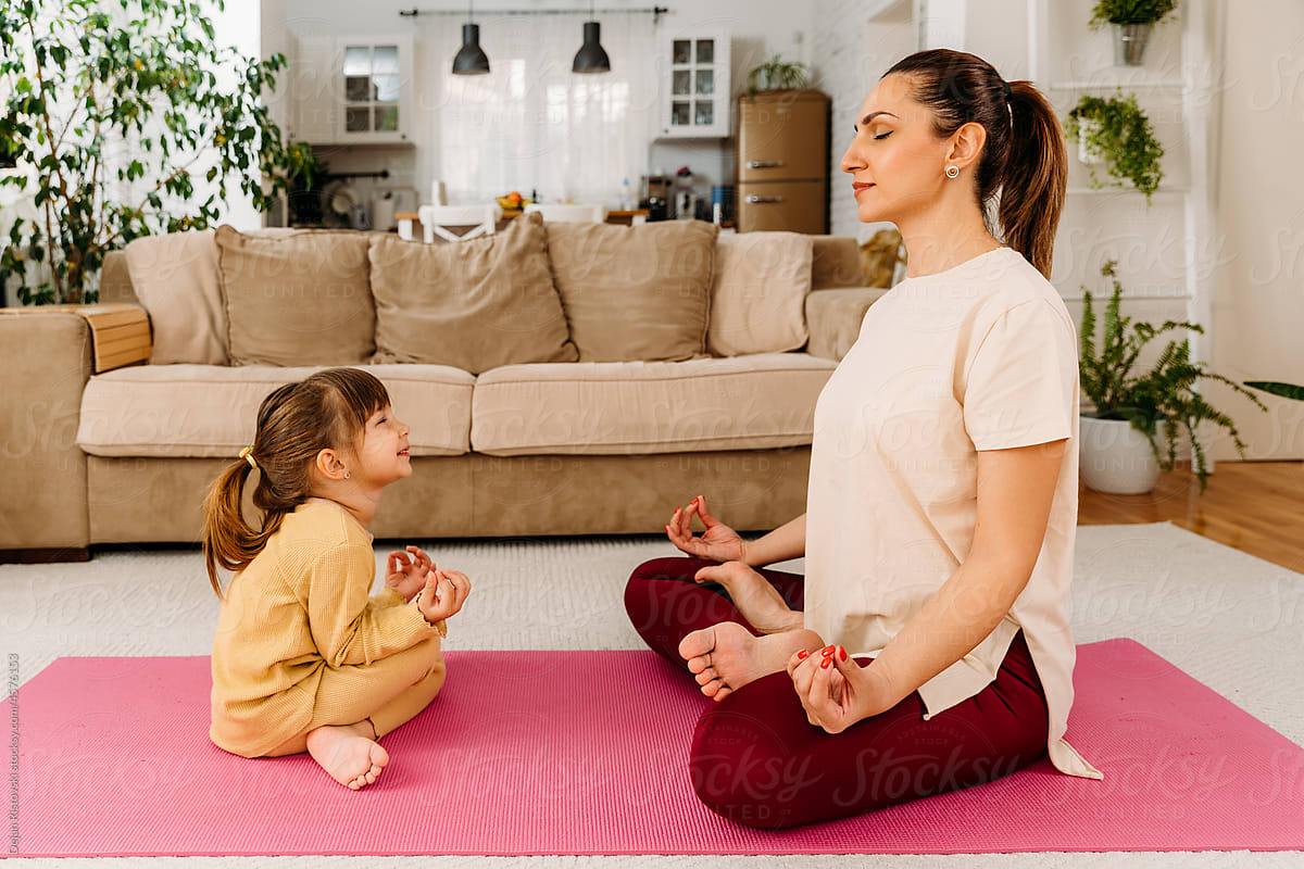 Mum teaching child to meditate