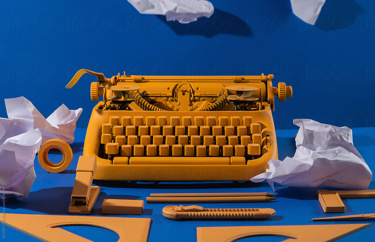 Yellow typewritter, office supplies,  papers.