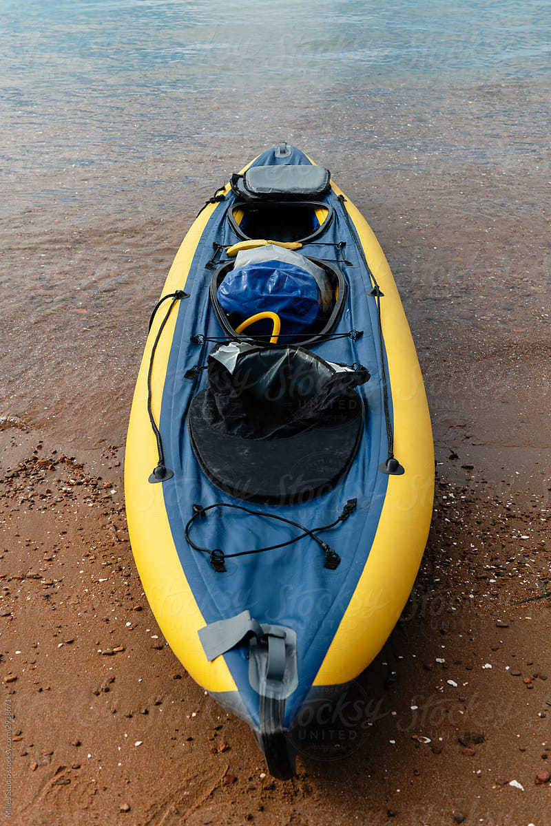 Modern kayak on wet seashore