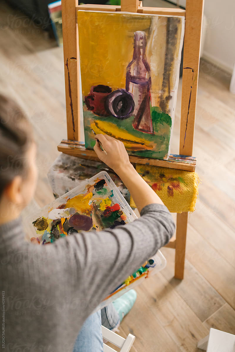 Female artist painting on canvas