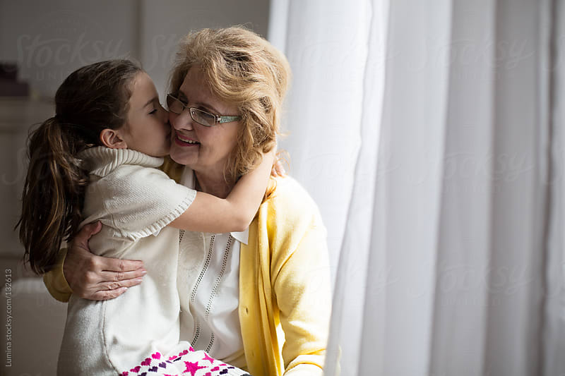 Girl Kissing Her Grandmother By Lumina Stocksy United