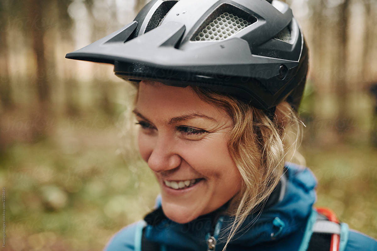 Smiling woman ready for mountain biking in the woods