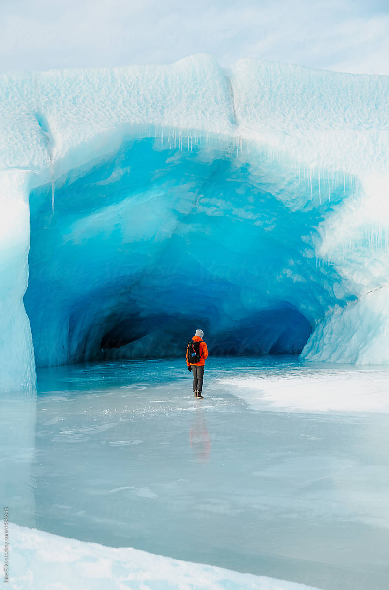 Young Male Hiker Explores Alaskan Glacier Cave