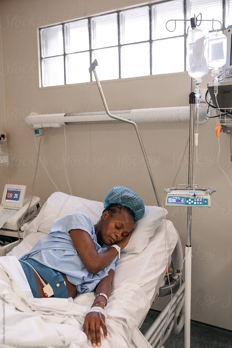 Pregnant African female sleeping in ward