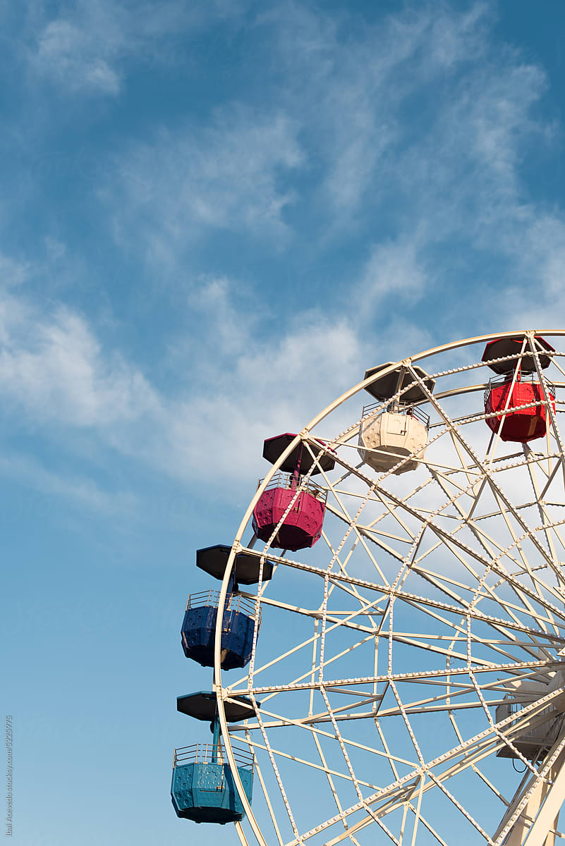 Ferris wheel with blue sky and clouds