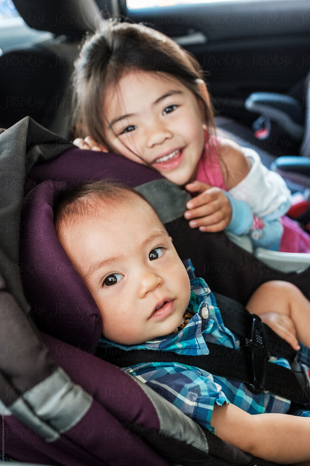 Mixed Race Children Sitting in a Car