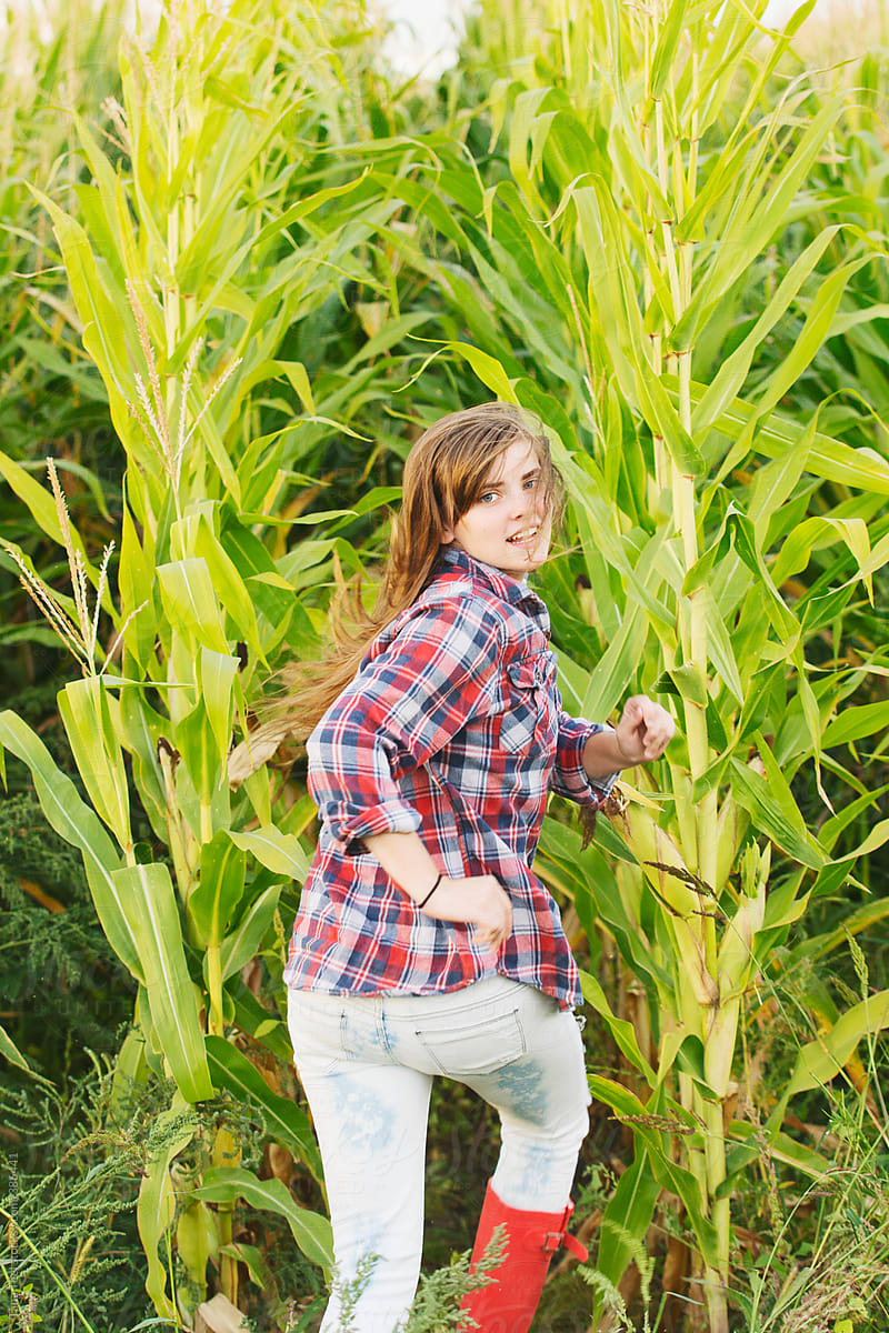 Teenager running in corn field